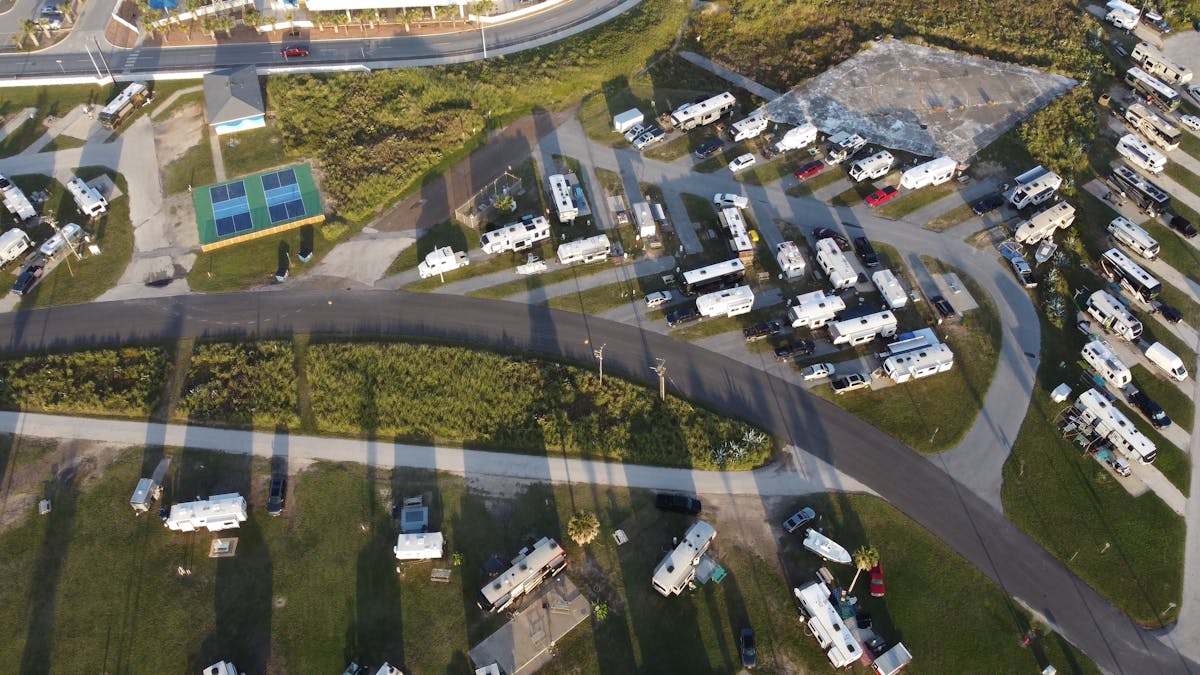Aerial view of an RV campground with numerous RVs and trailers parked at hookup sites