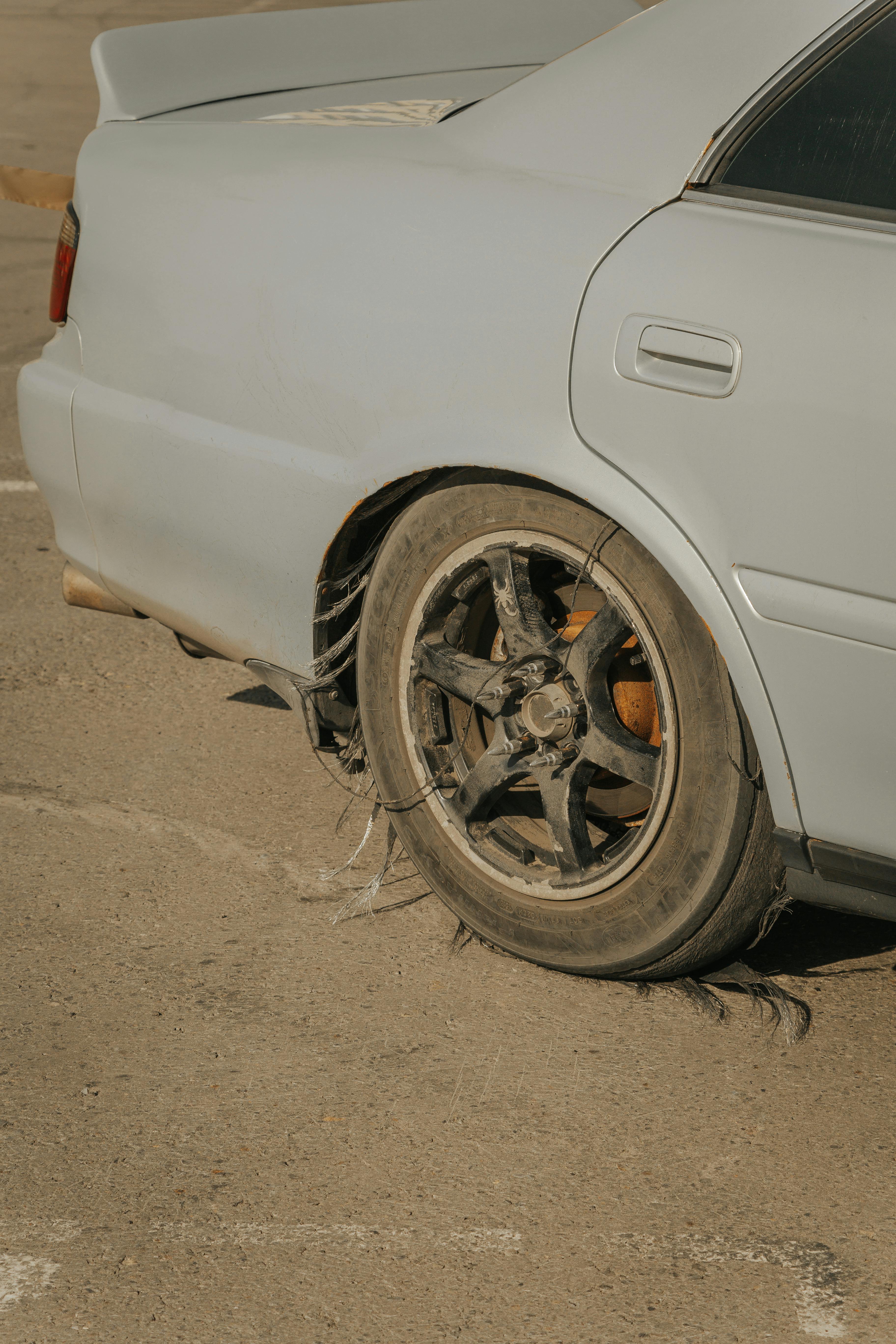 Close-up of a severely damaged tire showing structural failure