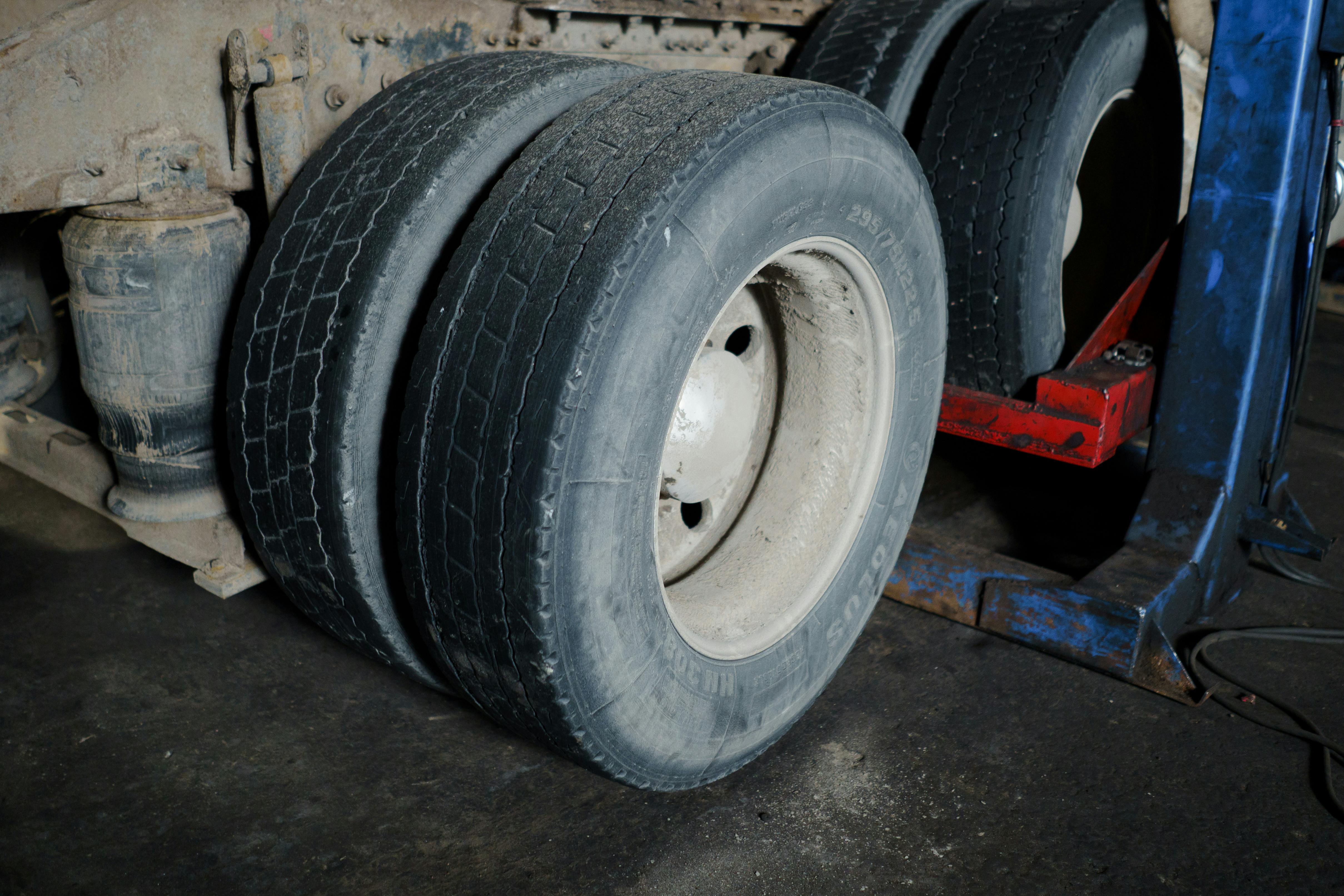 Close-up of stacked truck tires in an industrial garage awaiting maintenance