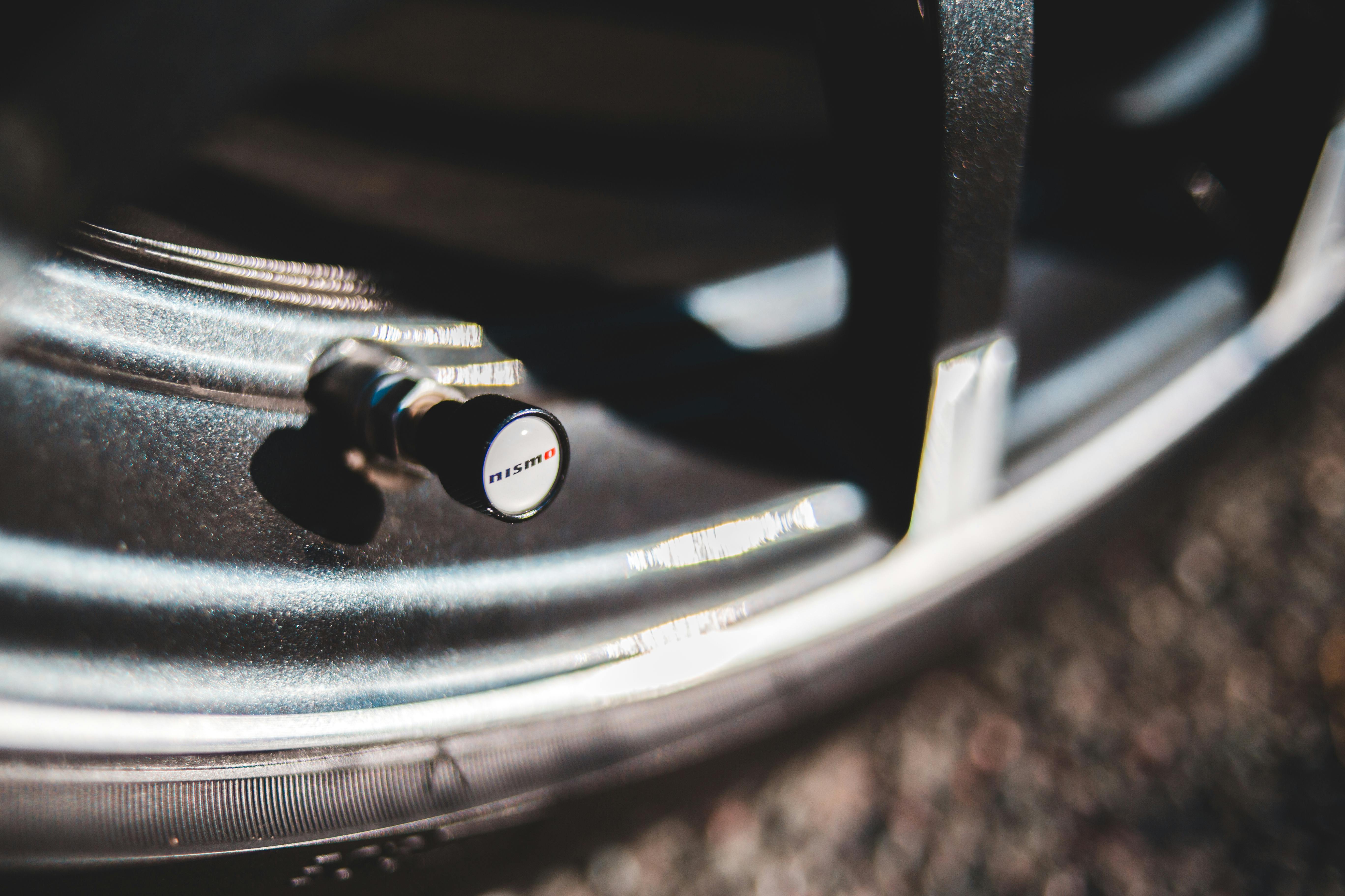Close-up of a tire valve stem on a modern alloy wheel